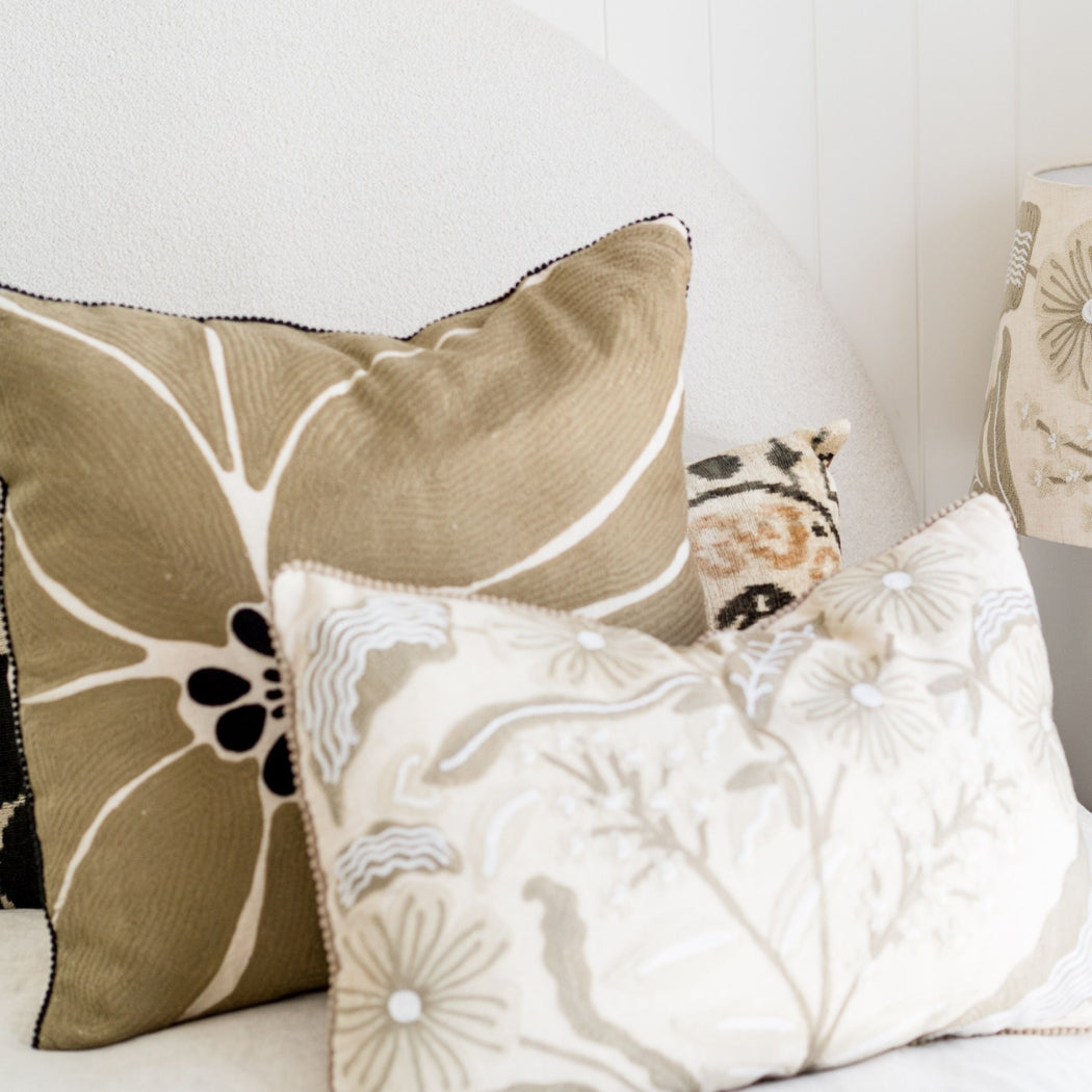  Embroidered Taupe pillow featuring an abstract flower design, the natural colour palate can be paired with just about anything. paired here with the Daisy lumber cushion for a light bright look
